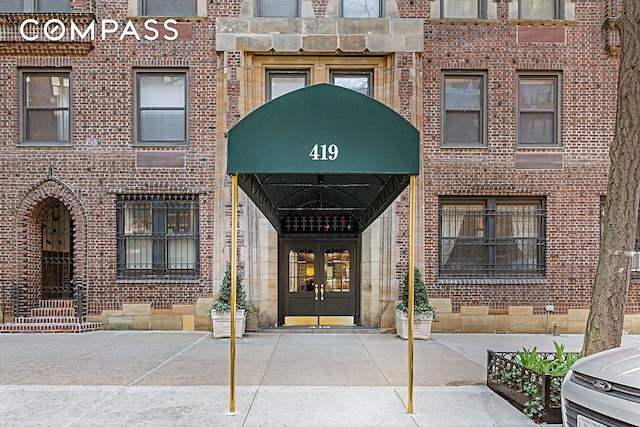 419 E 57th St Unit 6A, New York City, NY 10022 - doorway to property with french doors and brick siding