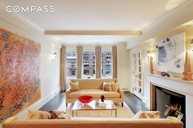 living room featuring beam ceiling, ornamental molding, and dark hardwood / wood-style floors