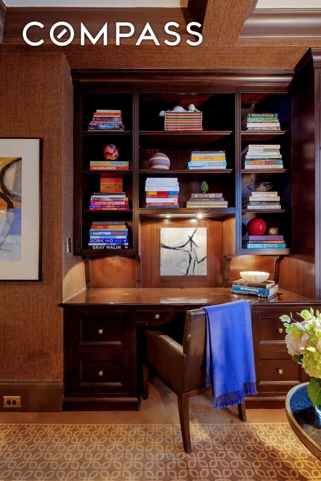 office area featuring built in shelves and built in desk