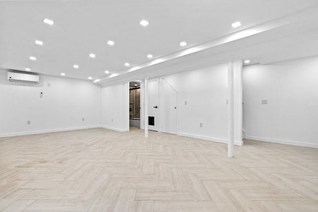 basement featuring light parquet flooring and a wall mounted air conditioner