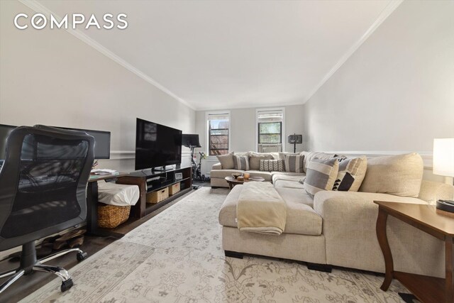 living room featuring crown molding and lofted ceiling