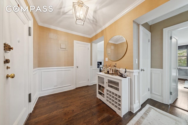 221 E 78th St Unit 4J, New York City, NY 10075 - entryway featuring a decorative wall, dark wood-type flooring, wainscoting, a chandelier, and ornamental molding