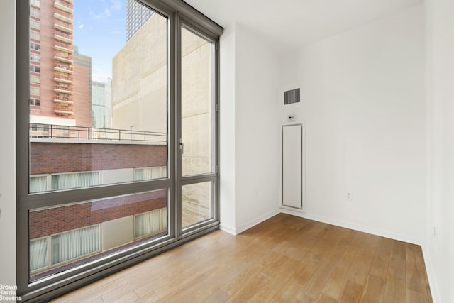 spare room with light hardwood / wood-style flooring