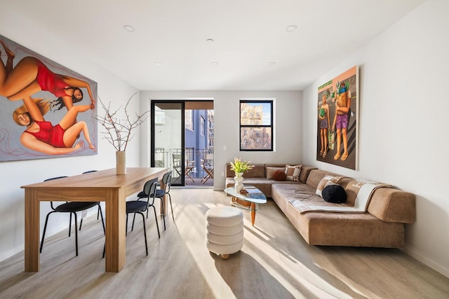 living area with light wood-style floors and baseboards