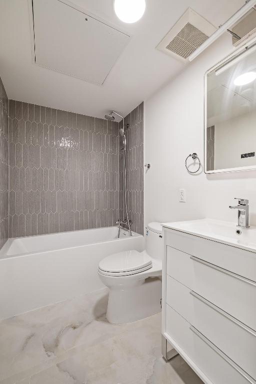 bathroom with toilet, shower / tub combination, visible vents, and vanity