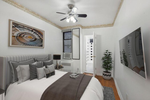 bedroom featuring radiator, ceiling fan, and hardwood / wood-style floors