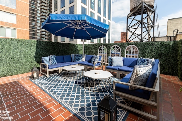 view of patio with an outdoor living space and fence