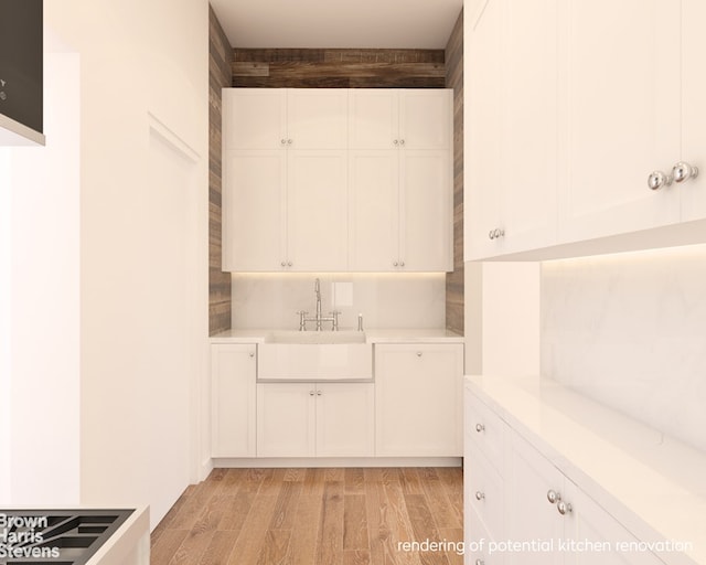 419 E 57th St Unit Ph16C, New York City, NY 10022 - kitchen featuring a sink, light wood-style flooring, light countertops, and white cabinets