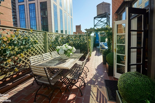 view of patio / terrace featuring a view of city and outdoor dining area