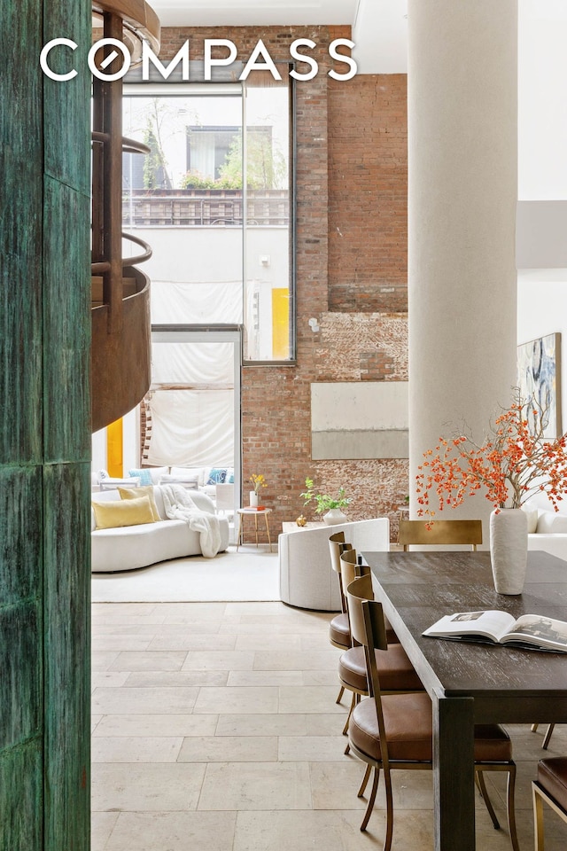 dining area featuring brick wall