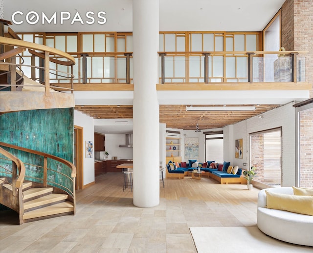 16 Jay St Unit 1, New York City, NY 10013 - community lobby featuring a towering ceiling, stairway, and brick wall
