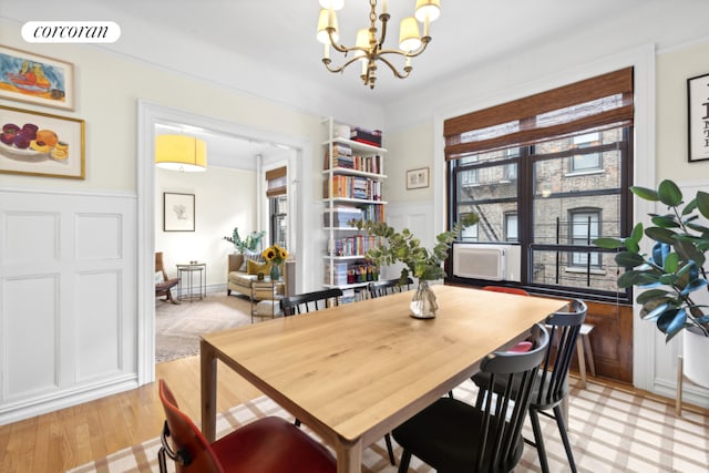 dining area featuring an inviting chandelier and light hardwood / wood-style flooring