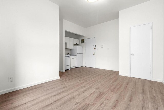 unfurnished living room with light hardwood / wood-style flooring