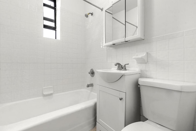 full bathroom with tile walls, tiled shower / bath combo, tasteful backsplash, vanity, and toilet