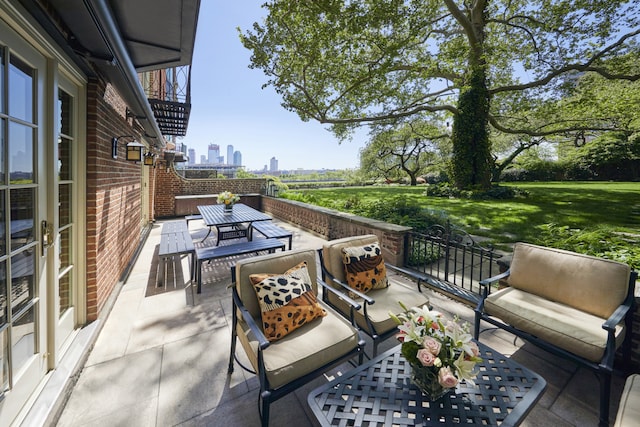 6 Sutton Sq, New York City, NY 10022 - view of patio with outdoor dining space, a view of skyline, and outdoor lounge area