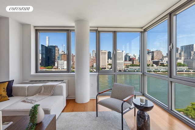 sunroom featuring a view of city, visible vents, and a healthy amount of sunlight