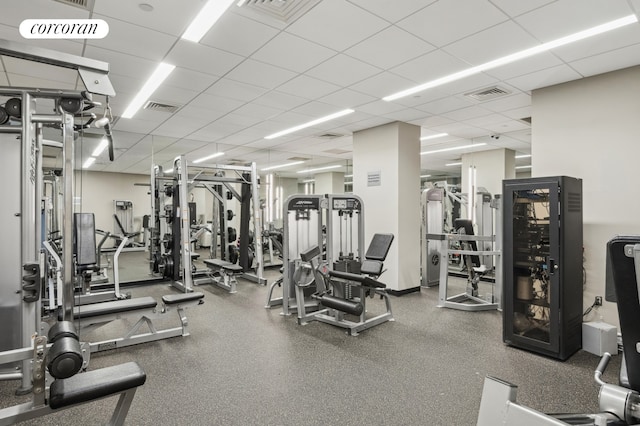 gym featuring visible vents and a drop ceiling