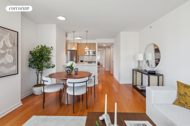 425 Main St Unit 12D, New York City, NY 10044 - dining area with light wood-style floors and recessed lighting