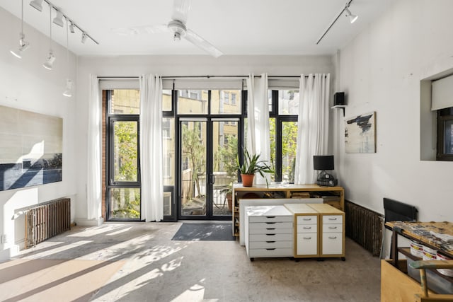 interior space with radiator and a wealth of natural light