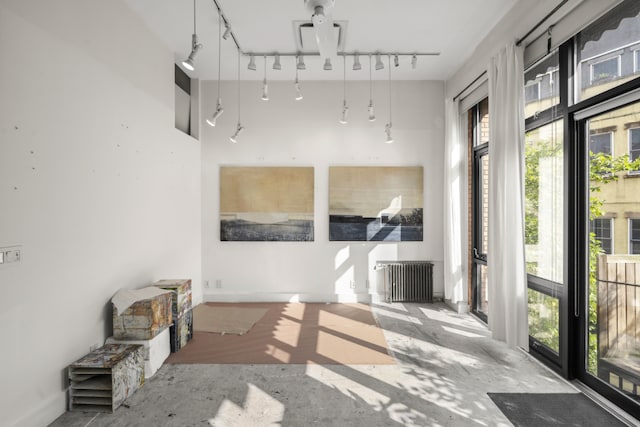 sunroom with radiator heating unit and rail lighting