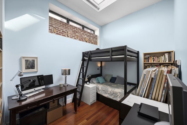 bedroom featuring dark wood-type flooring and a skylight