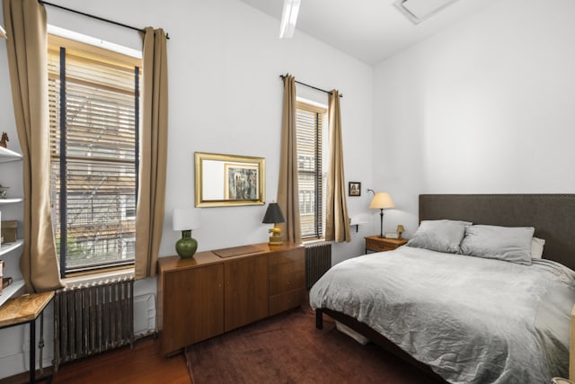 bedroom featuring dark hardwood / wood-style flooring and radiator heating unit