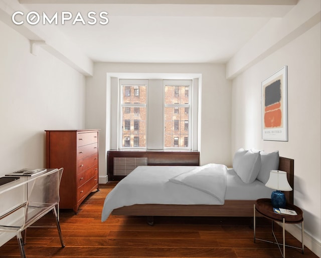 bedroom with baseboards, radiator, and dark wood-style flooring