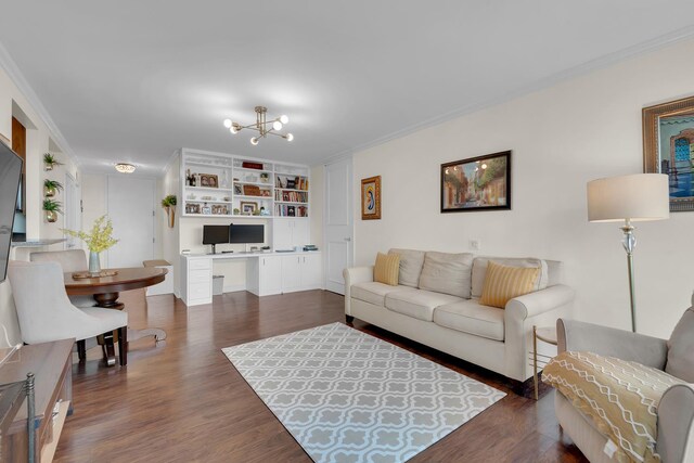 living area with a chandelier, built in features, ornamental molding, built in desk, and dark wood-style floors