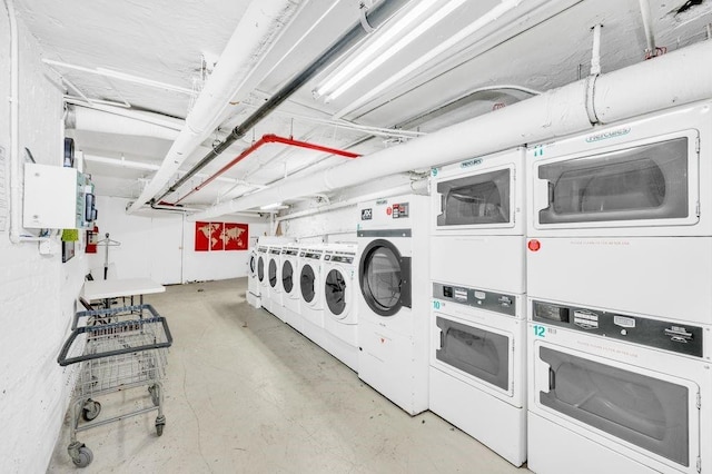 washroom with stacked washing maching and dryer and independent washer and dryer