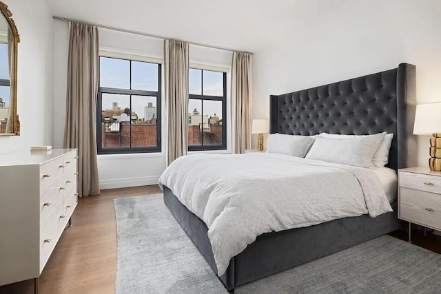 bedroom with dark hardwood / wood-style floors