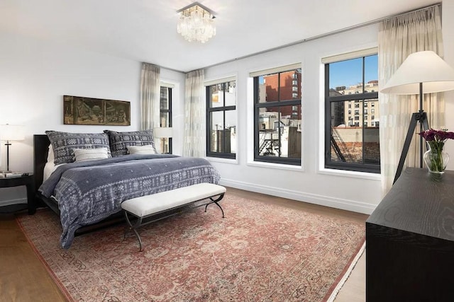 bedroom with wood-type flooring and a chandelier