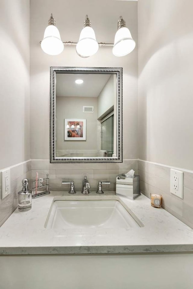 57 E 75th St Unit 2R, New York City, NY 10021 - bathroom with vanity and backsplash