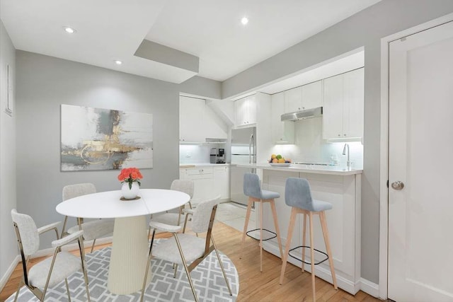 57 E 75th St Unit 2R, New York City, NY 10021 - dining room featuring light wood-style flooring, recessed lighting, and baseboards