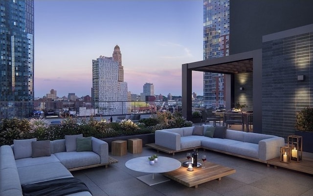 patio terrace at dusk featuring an outdoor living space and a city view