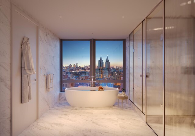 full bath with a view of city, a soaking tub, and marble finish floor