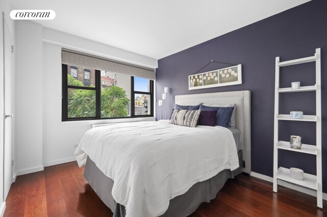 bedroom with dark wood-type flooring