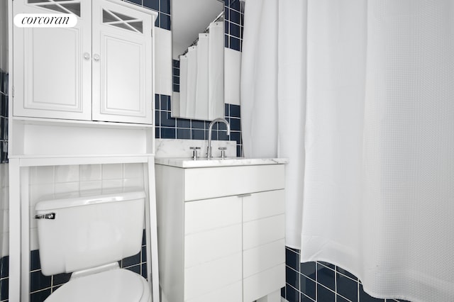 115 E 9th St Unit 6R, New York City, NY 10003 - full bathroom with tile walls, toilet, vanity, a shower with shower curtain, and tasteful backsplash