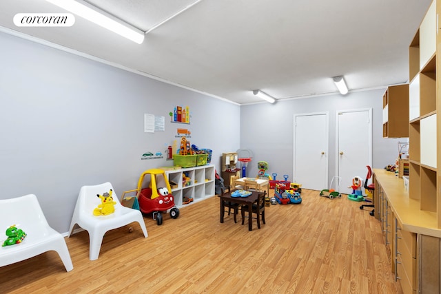 game room with light hardwood / wood-style floors