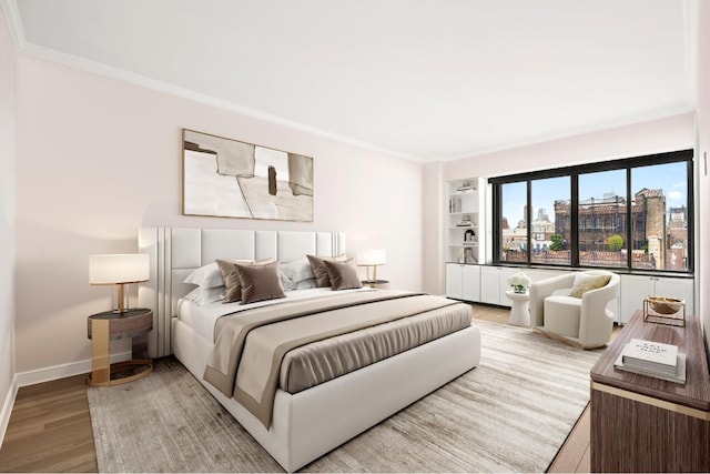 bedroom with wood-type flooring and ornamental molding