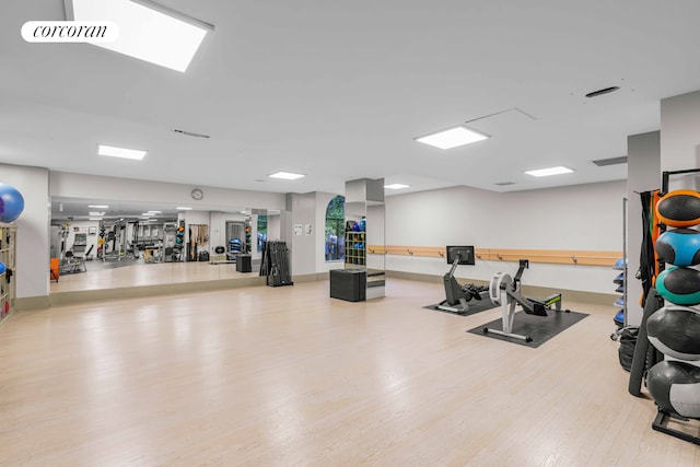 exercise room featuring visible vents and wood finished floors