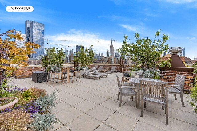 view of patio featuring a view of city and outdoor dining area