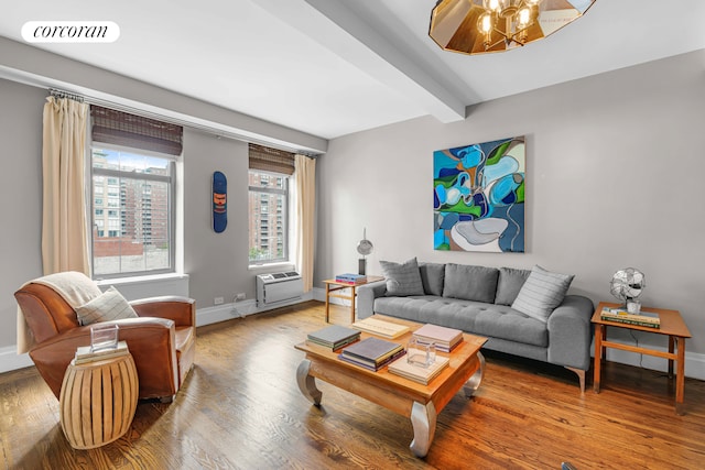 living room with wood finished floors, visible vents, baseboards, beamed ceiling, and a wall mounted air conditioner