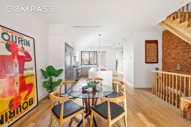 office area featuring a fireplace and light hardwood / wood-style floors