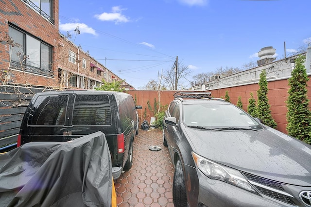 view of parking with fence