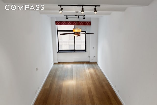 interior space featuring wood finished floors and baseboards