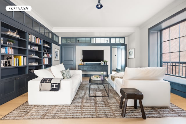 living room with built in features, wood finished floors, visible vents, and ornamental molding