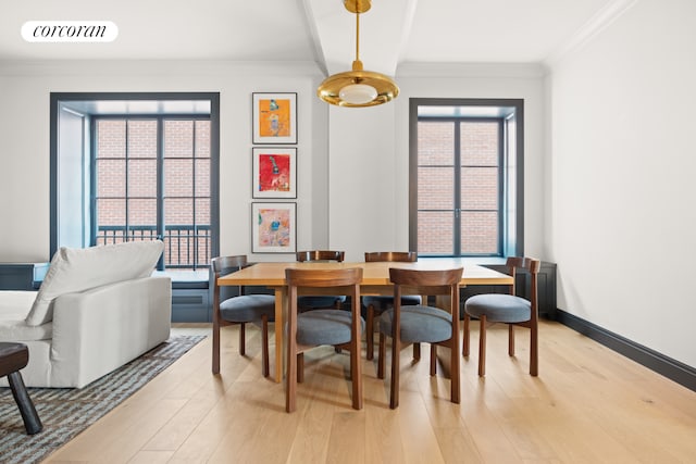 dining space with ornamental molding, a healthy amount of sunlight, visible vents, and light wood-style flooring