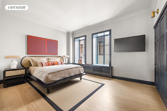 bedroom with ornamental molding, light wood-type flooring, visible vents, and baseboards