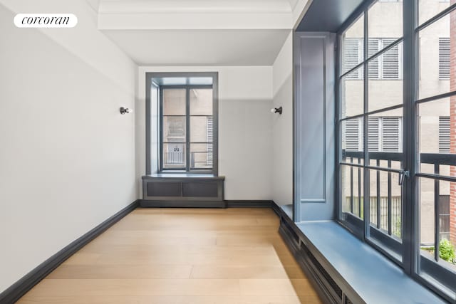 interior space with light wood-style floors, baseboards, and visible vents