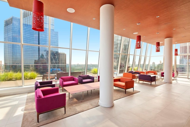 community lobby with a wall of windows, a high ceiling, and a city view